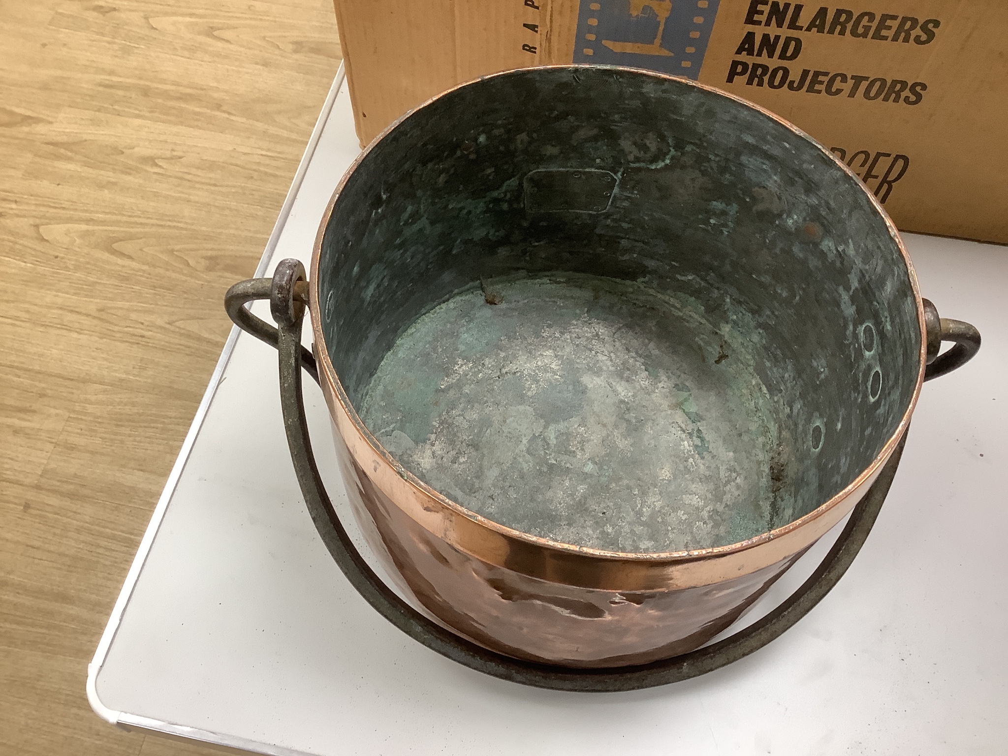 A French copper cooking pot and cover with swing handle, 27cm high